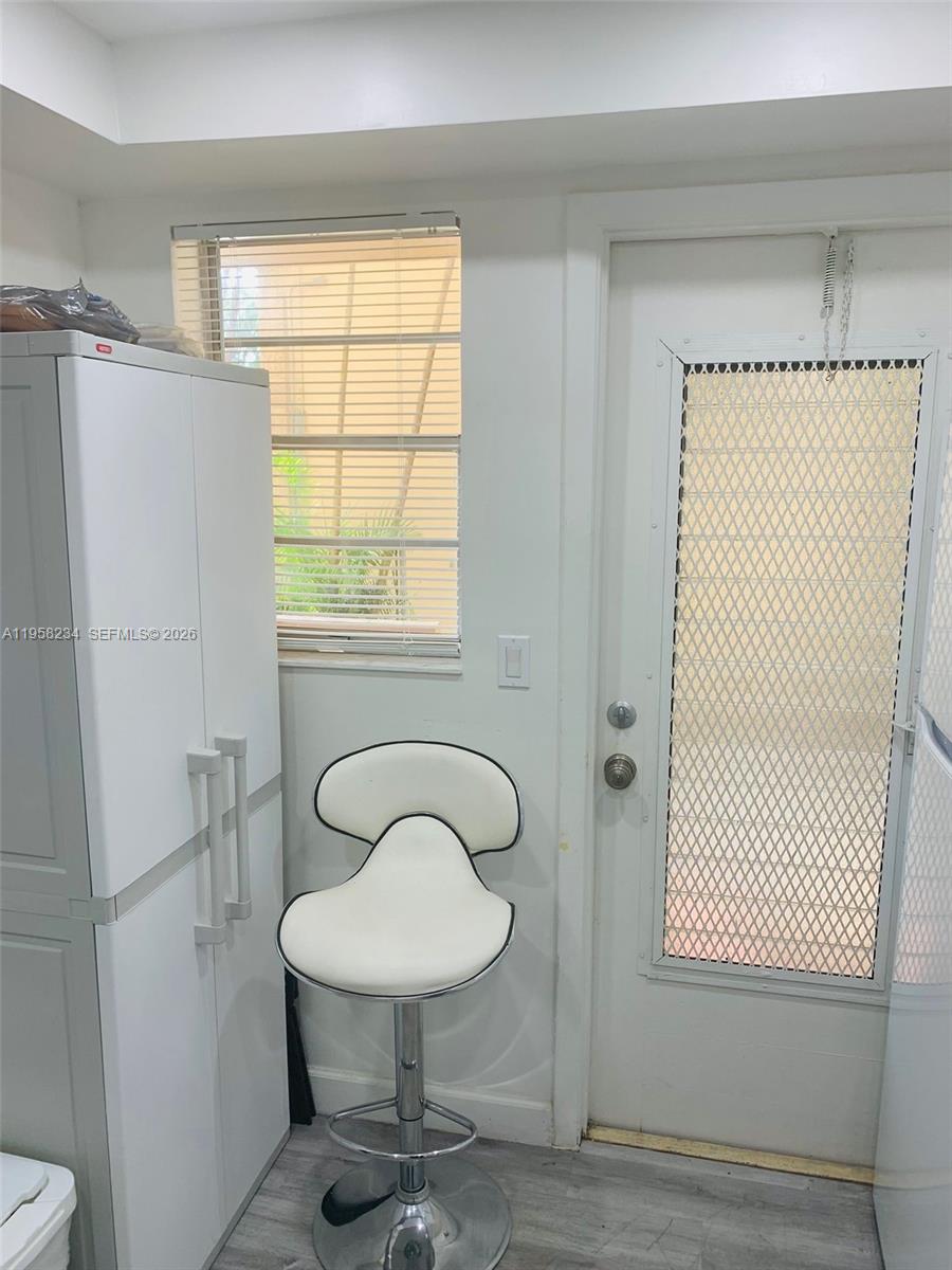 A white bar stool sits in a room with a white cabinet and a door — 1333 HALLANDALE BEACH BL # 131, Hallandale Beach FL 33009, HALLANDALE BEACH, FL