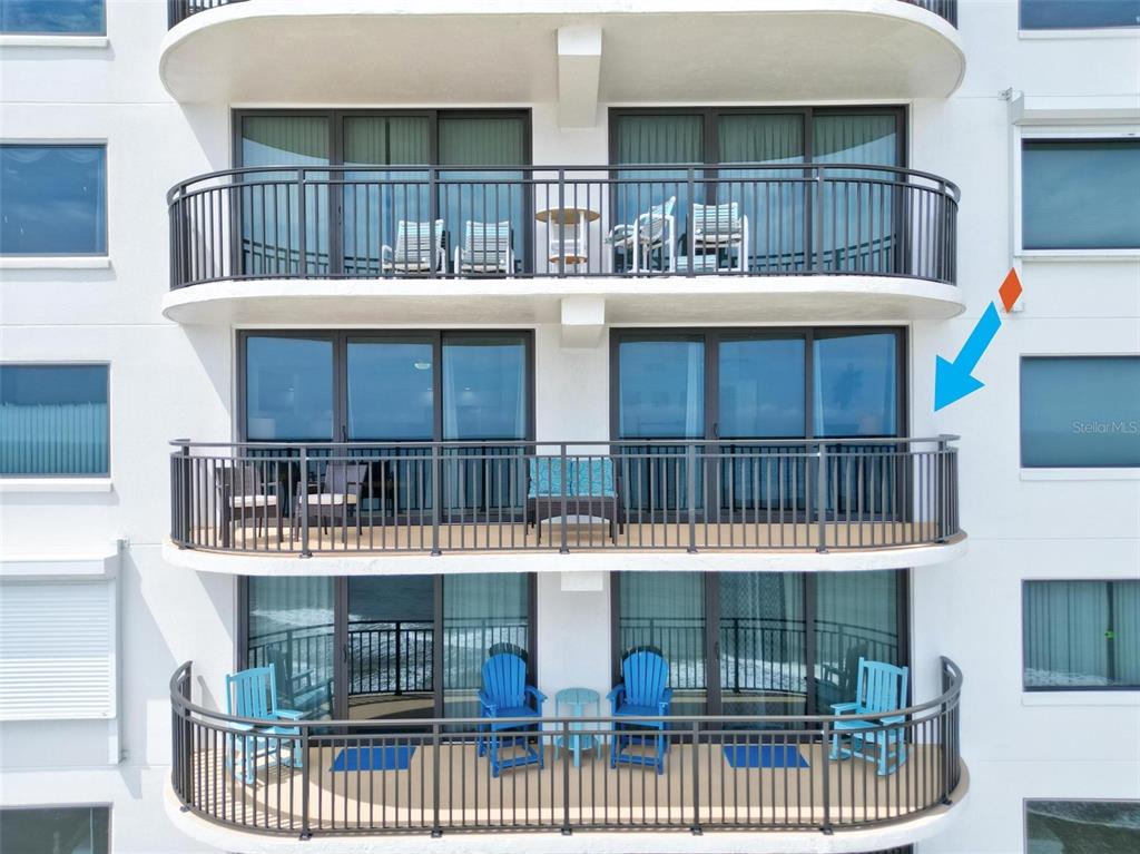 An exterior view shows three stacked balconies with railings and patio furniture on a building — 2555 S ATLANTIC AVENUE UNIT 1704, DAYTONA BEACH SHORES, FL
