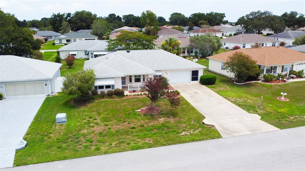 An aerial view shows a single-story house with a light-colored roof and a concrete driveway — 8480 SW 61ST TERRACE ROAD, OCALA, FL