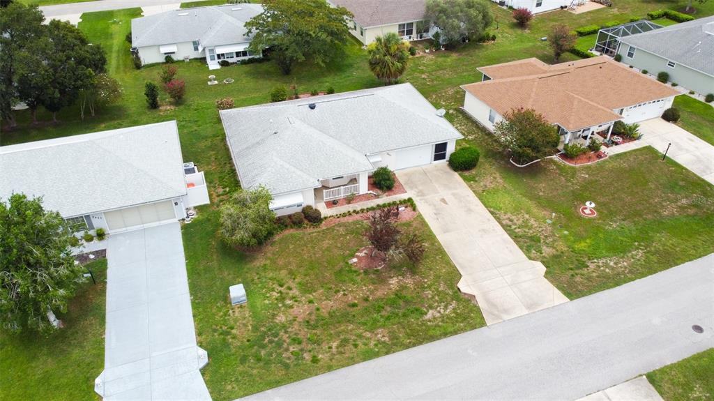 An aerial view of a suburban neighborhood featuring several single-story houses with driveways and lawns — 8480 SW 61ST TERRACE ROAD, OCALA, FL