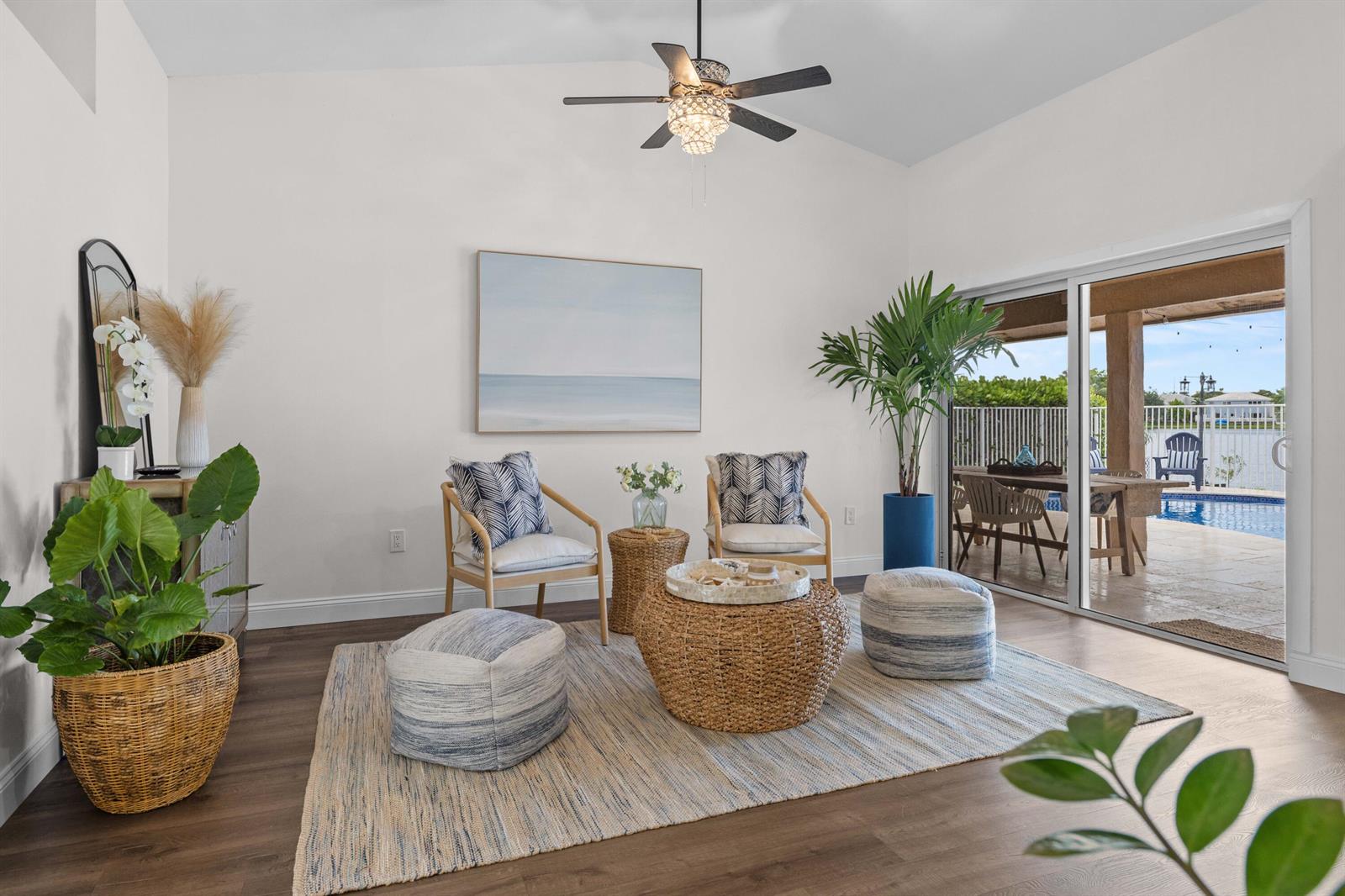 A bright living room features two chairs, a woven coffee table, and a sliding glass door — 14211 Appalachian Trail, Davie FL 33325, DAVIE, FL