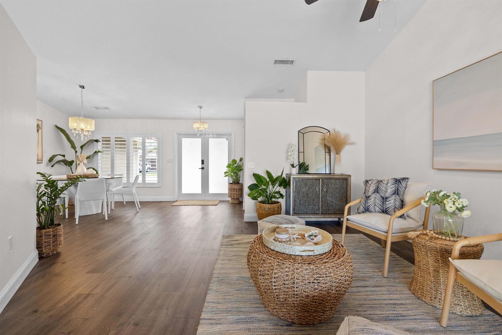 A bright living and dining area features wood-look flooring, white walls, and coastal-style decor — 14211 Appalachian Trail, Davie FL 33325, DAVIE, FL