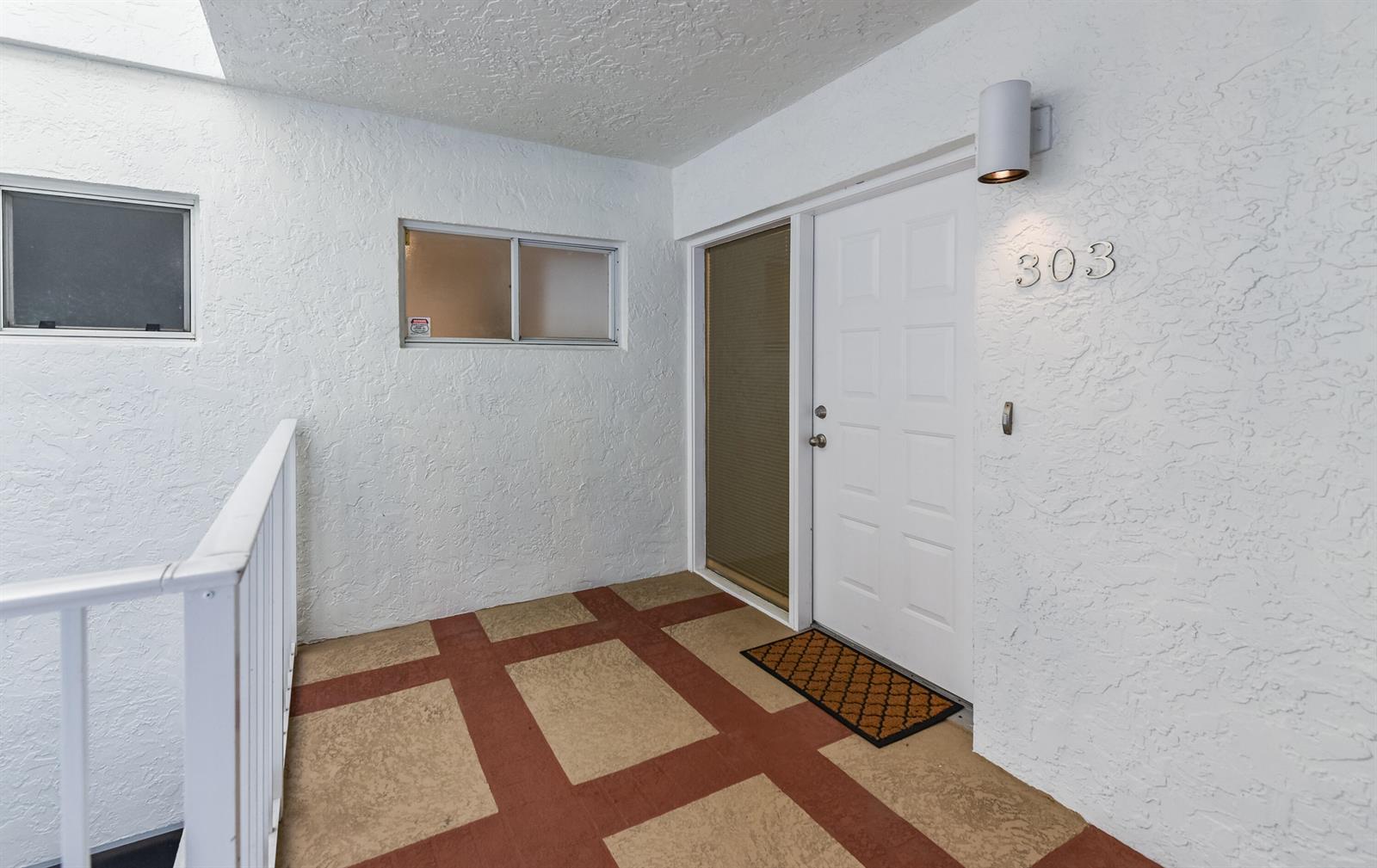 An exterior entryway features a white door labeled 303, a sidelight, and patterned floor tiles — 7369 Orangewood Lane # 303, Boca Raton FL 33433, BOCA RATON, FL