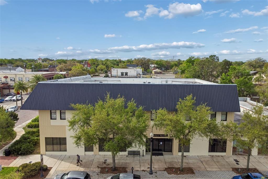 An aerial view of a two-story commercial building with a dark metal roof — 201 W 1ST STREET, SANFORD, FL
