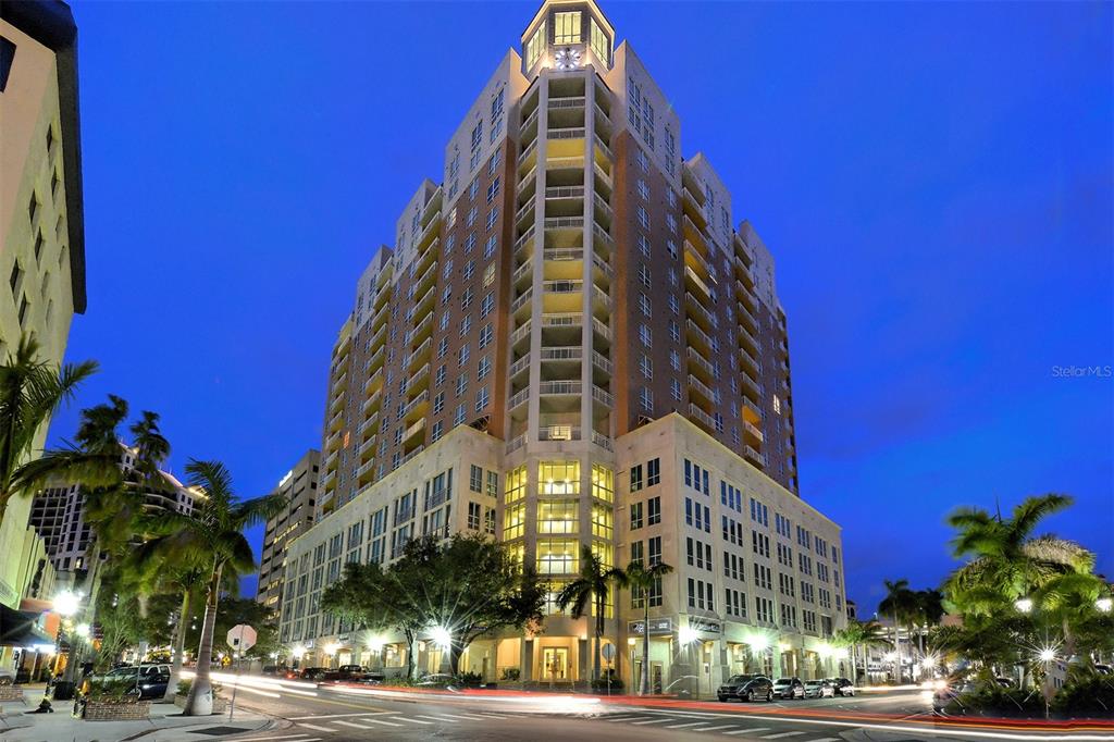 A tall, multi-story residential building with a corner entrance stands at a street intersection — 1350 MAIN STREET UNIT 1702, SARASOTA, FL