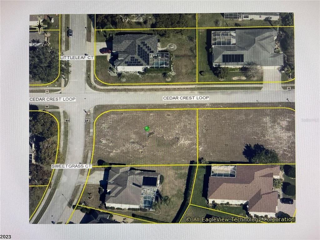 This aerial map shows two vacant residential lots located at a street intersection — 3460 SWEETGRASS COURT, SPRING HILL, FL