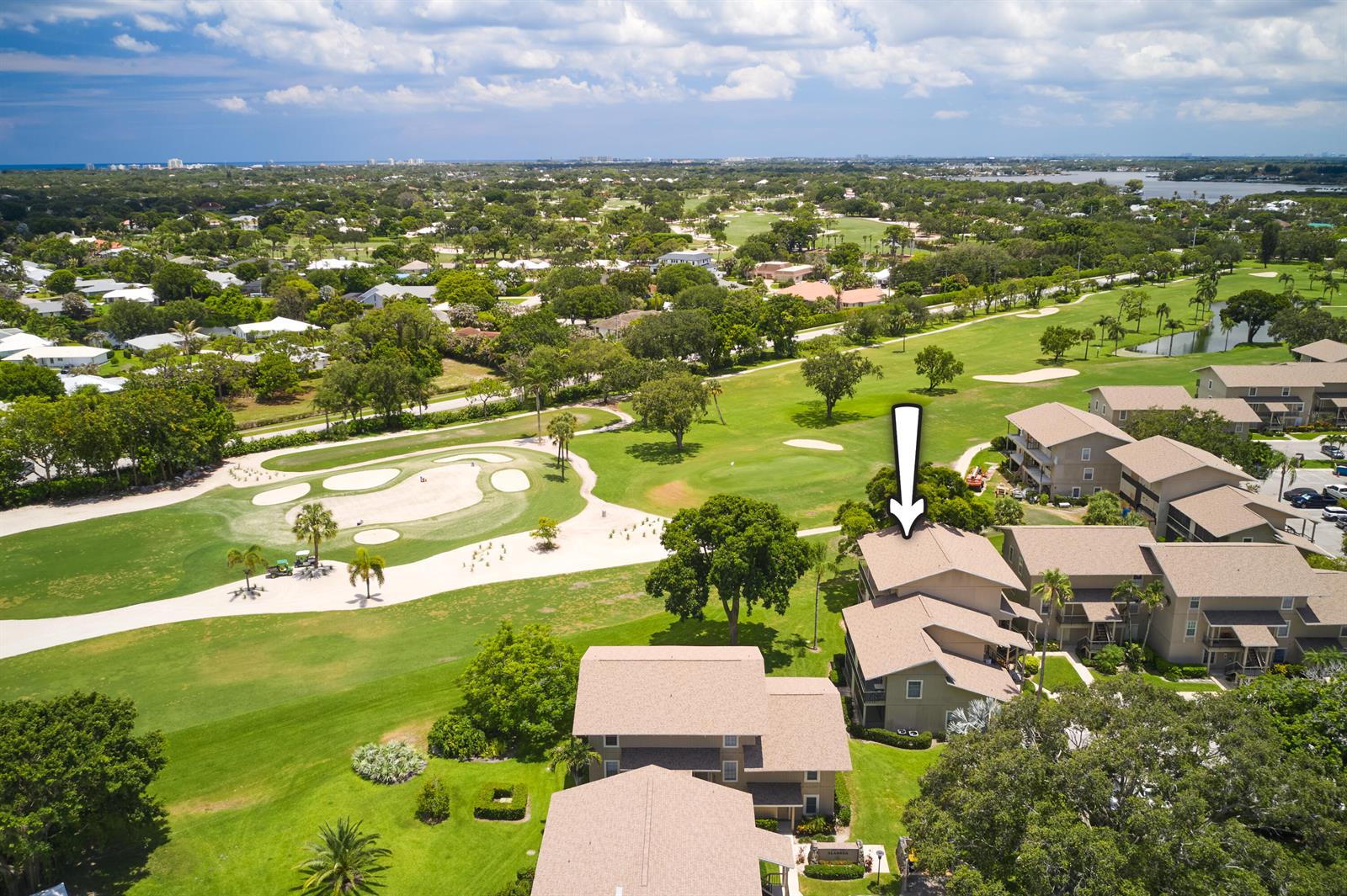 An aerial view shows a multi-story residential building adjacent to a golf course — 18369 SE Wood Haven Lane, Jupiter FL 33469, JUPITER, FL
