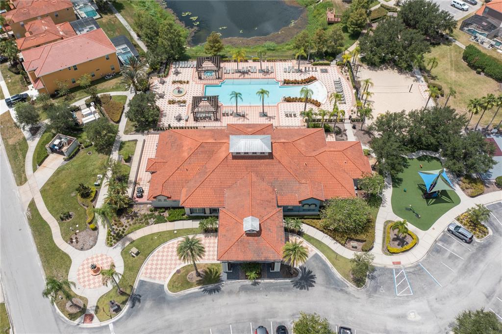 An aerial view shows a community clubhouse with a pool, playground, and parking lot — 1091 MARCELLO BOULEVARD, KISSIMMEE, FL