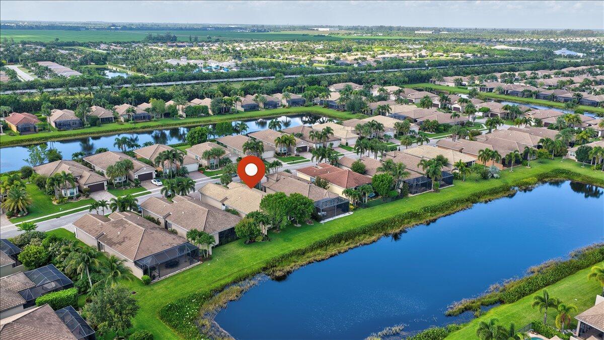 An aerial view of a suburban neighborhood featuring houses with pools surrounding a large lake — 8681 Cathedral Peak Court, Boynton Beach FL 33473, BOYNTON BEACH, FL