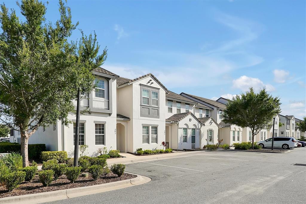 A multi-unit residential building with beige stucco walls and a parking lot in front — 297 CAPTIVA DRIVE, DAVENPORT, FL