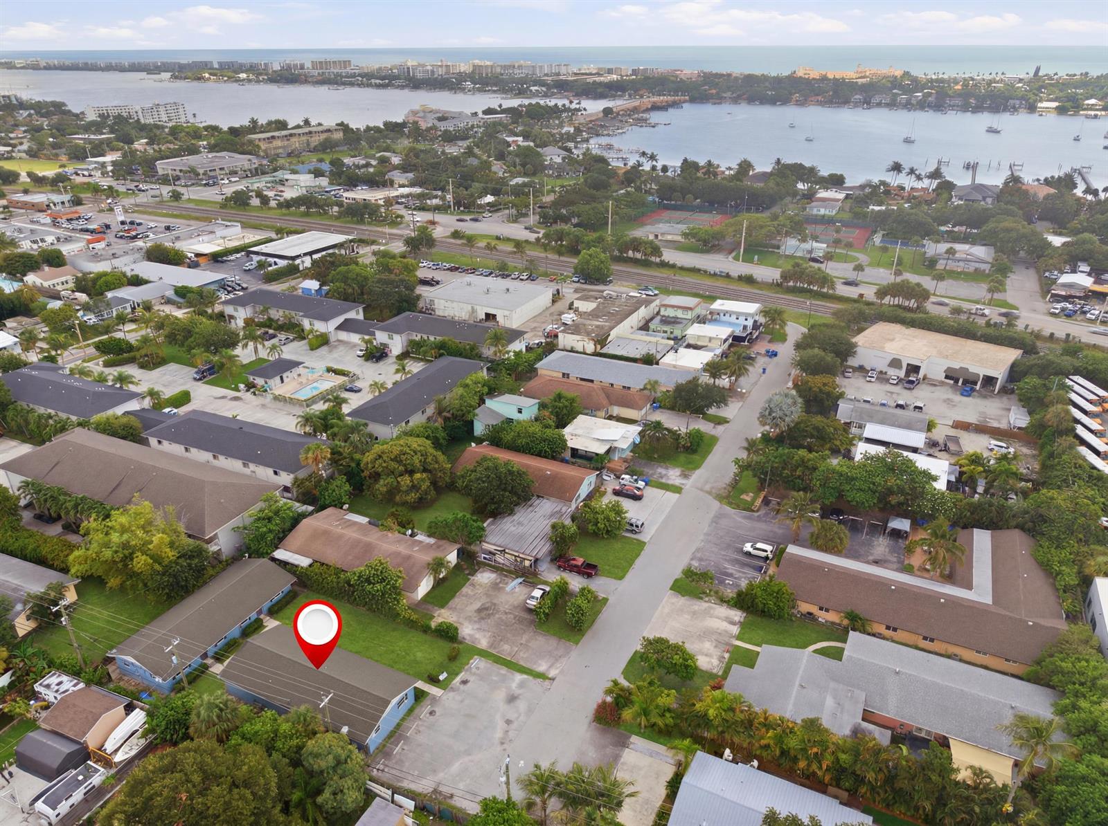 An aerial view shows a residential neighborhood with a marked house near a bay — 351 Wickline Boulevard, Lantana FL 33462, LANTANA, FL