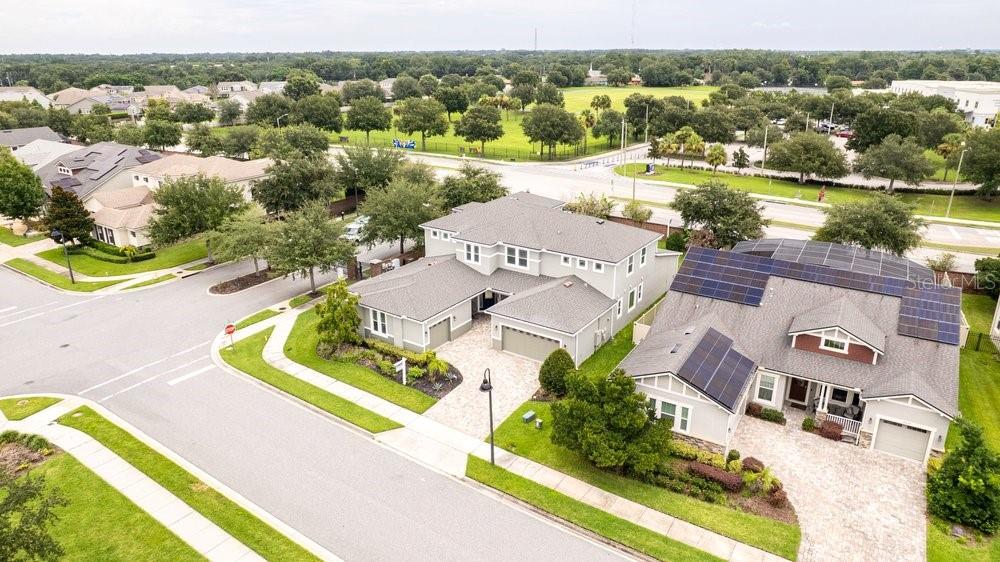 An aerial view shows two suburban houses with paved driveways and solar panels on roofs — 14825 ELLINGSWORTH LANE, WINTER GARDEN, FL
