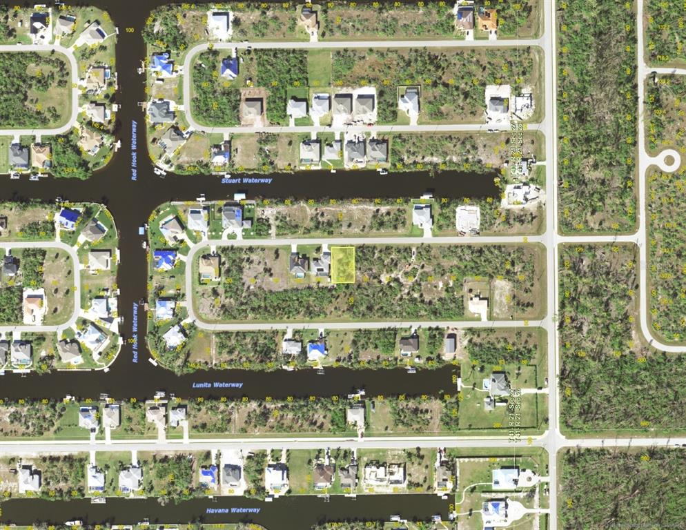 An aerial map view shows a highlighted vacant residential lot in a suburban canal community — 15595 STUART CIRCLE, PORT CHARLOTTE, FL