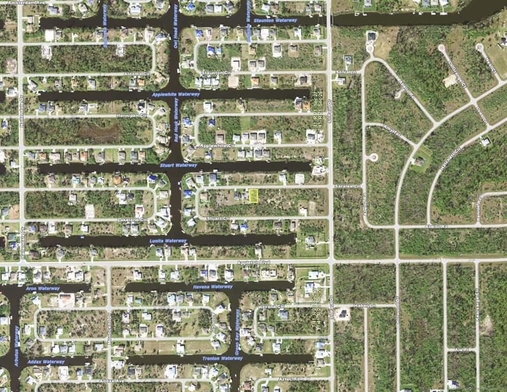 This is an aerial map view of a residential neighborhood with canals and street layouts — 15595 STUART CIRCLE, PORT CHARLOTTE, FL