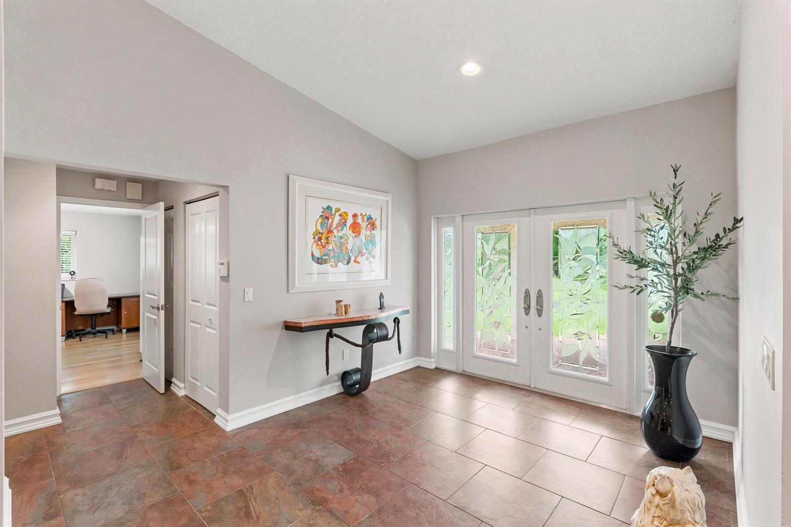 A foyer with tile flooring, a console table, double glass-paneled doors, and an office visible — 22829 Horse Shoe Way, Boca Raton FL 33428, BOCA RATON, FL