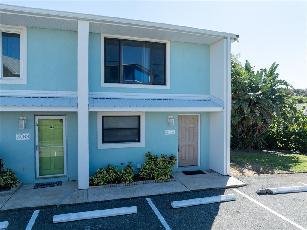 A two-story light blue building features two unit entrances labeled B3 and B4 — 4786 S ATLANTIC AVENUE UNIT 4B, PONCE INLET, FL