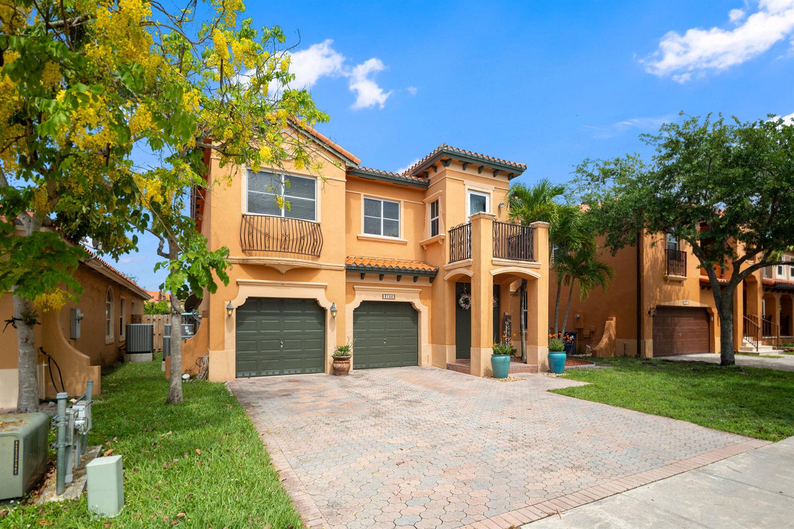 A two-story stucco house with a two-car garage, a balcony, and a paved driveway — 3144 SW 154th Place, Miami FL 33185, MIAMI, FL