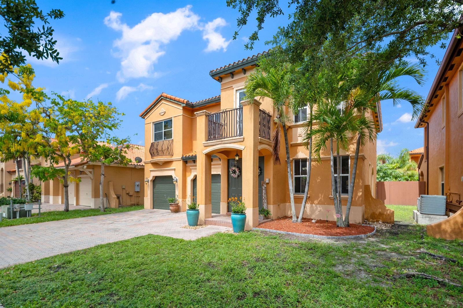 A two-story orange stucco house with a tile roof, balcony, and a paved driveway — 3144 SW 154th Place, Miami FL 33185, MIAMI, FL