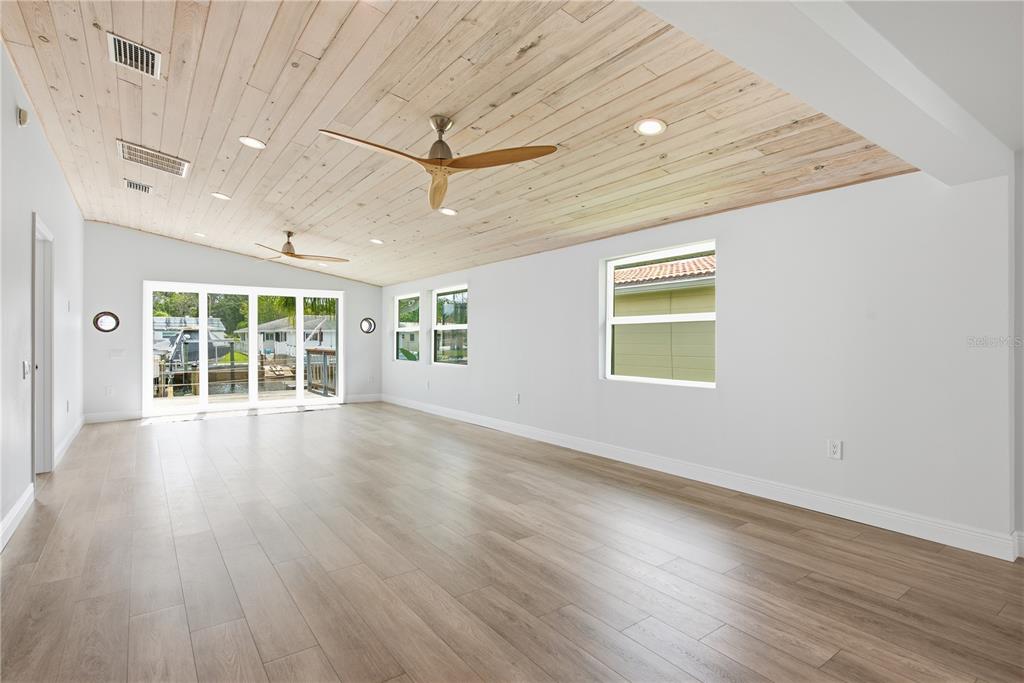 This is a floor plan for a single-story home with three bedrooms and a deck — 4930 POMPANO DRIVE, NEW PORT RICHEY, FL
