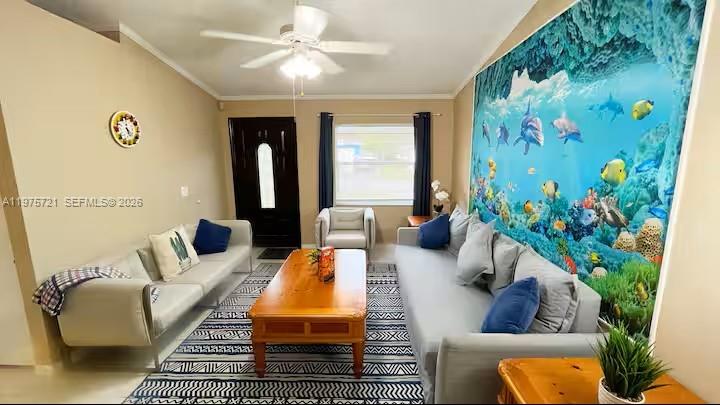 A living room features two sofas, a wooden coffee table, and a large underwater-themed wall mural — 404 Red Hawk Loop, Winter Haven FL 33880, WINTER HAVEN, FL