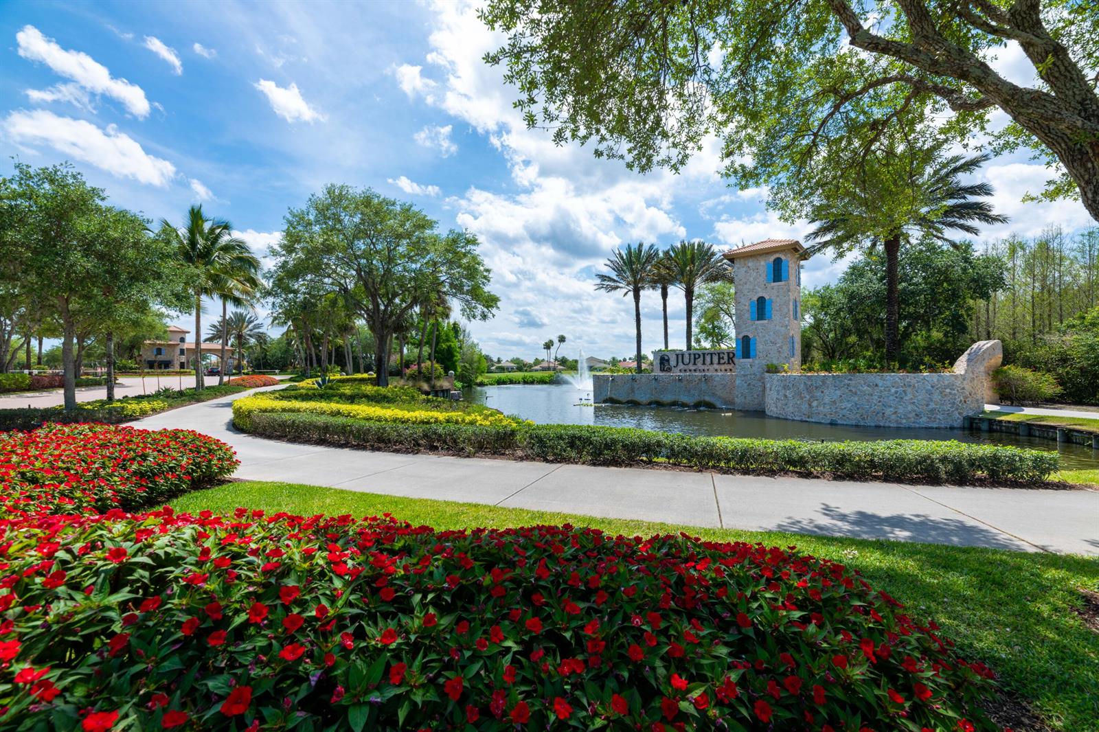 A stone tower and fountain mark the entrance to the Jupiter Country Club community — 160 Carina Drive, Jupiter FL 33478, JUPITER, FL