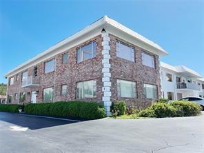 A multi-story brick apartment building with white trim and a paved parking lot — 310 S Cypress Road # 729, Pompano Beach FL 33060, POMPANO BEACH, FL