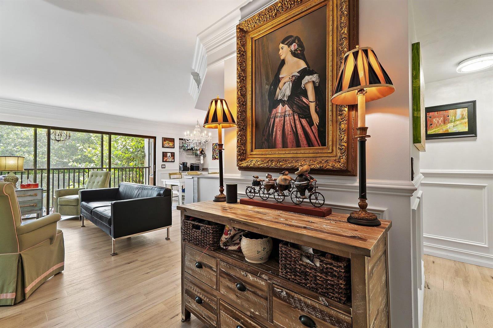 A wooden console table with lamps and a portrait sits in a living room area — 1605 S Us Highway 1 # F202, Jupiter FL 33477, JUPITER, FL