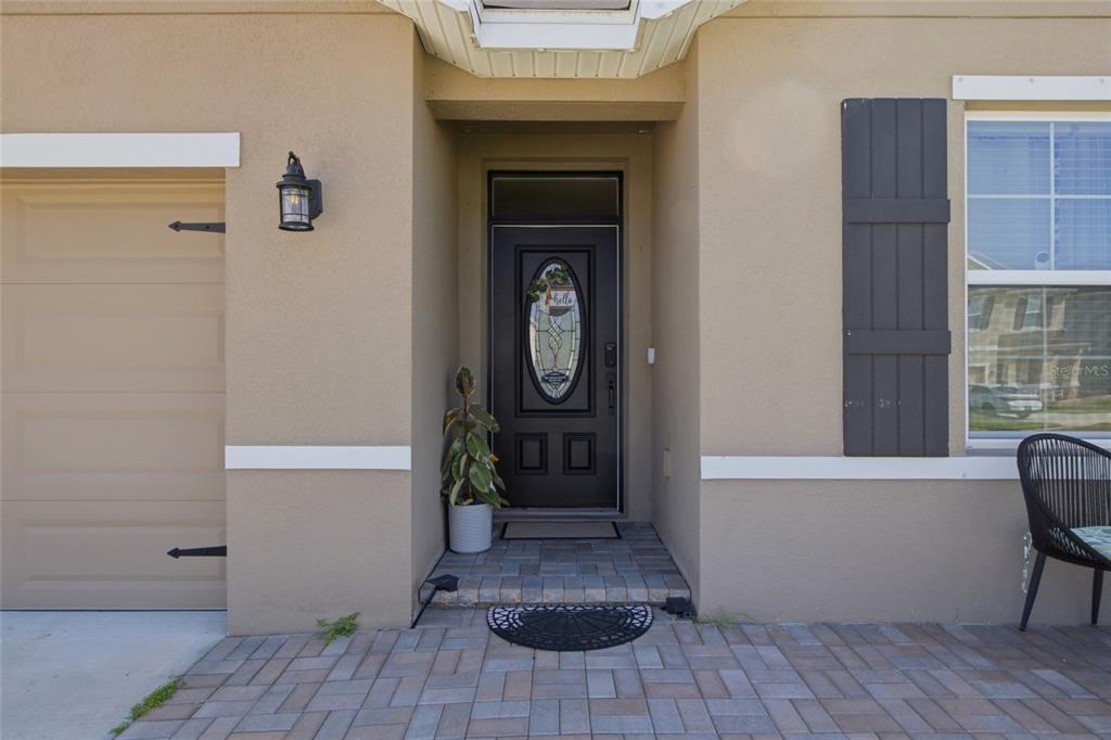 A kitchen features dark wood cabinets, granite countertops, stainless steel appliances, and a central island — 2927 LIVING CORAL DRIVE, ODESSA, FL