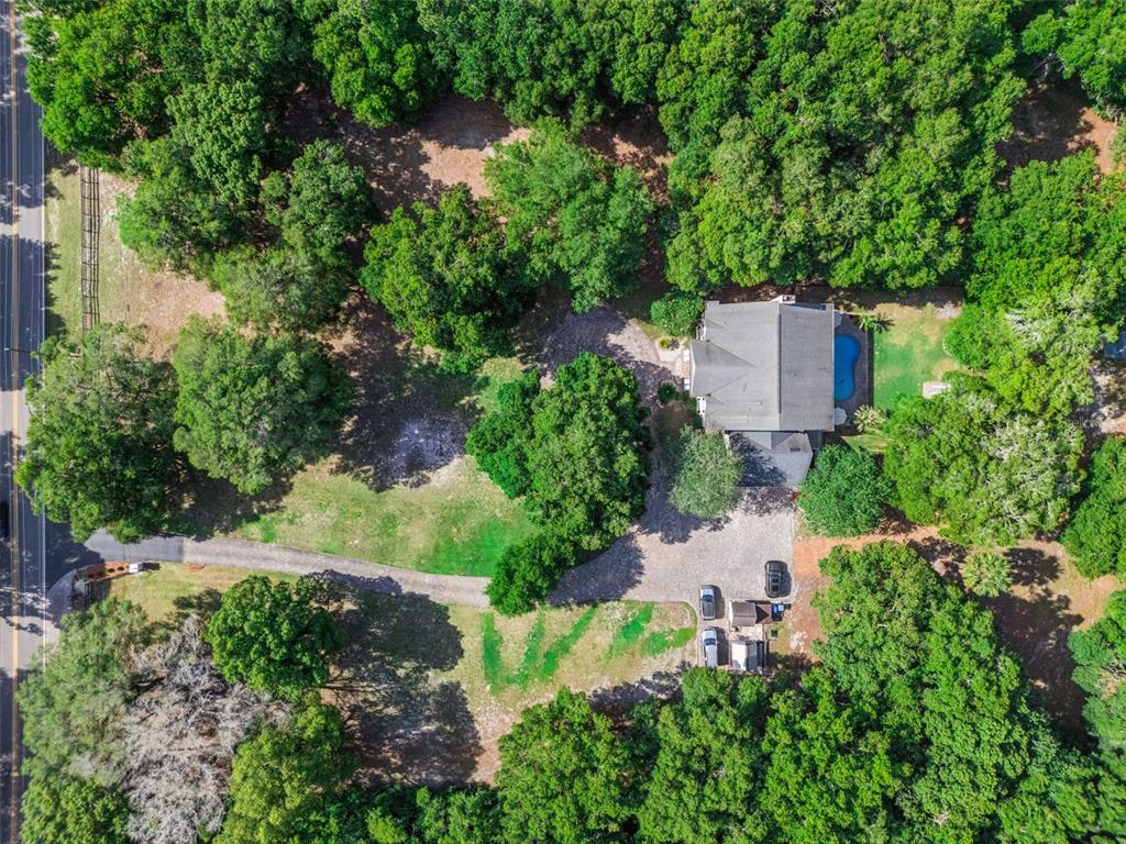 An aerial view of a house with a pool surrounded by trees and a driveway — 4275 ROUND LAKE ROAD, APOPKA, FL