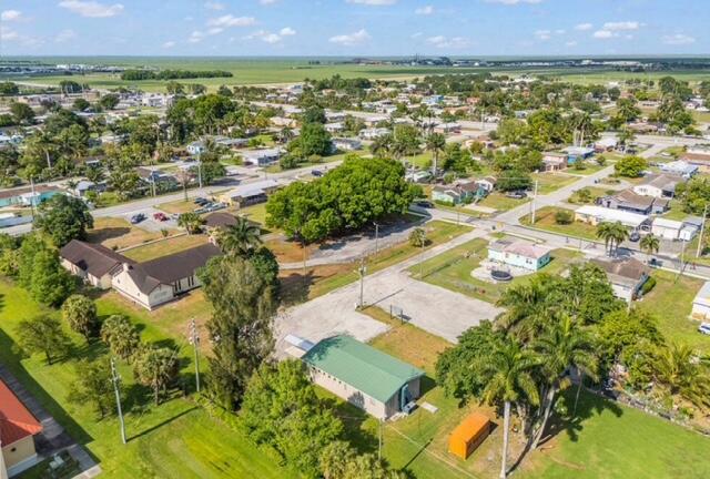 An aerial view shows a small town with houses, a church, and a green-roofed building — 224 NW G Avenue, Belle Glade FL 33430, BELLE GLADE, FL