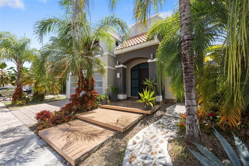A two-story house with a tiled entryway, palm trees, and a stone walkway — 677 PASEO LOS CORALES I, MAR INDICO ST UNIT F-10, DORADO, PR