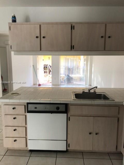 A kitchen features light wood cabinets, a tiled countertop, a stainless steel sink, and a dishwasher — 15401 SW 81st Cir Ln # 16, Miami FL 33193, MIAMI, FL