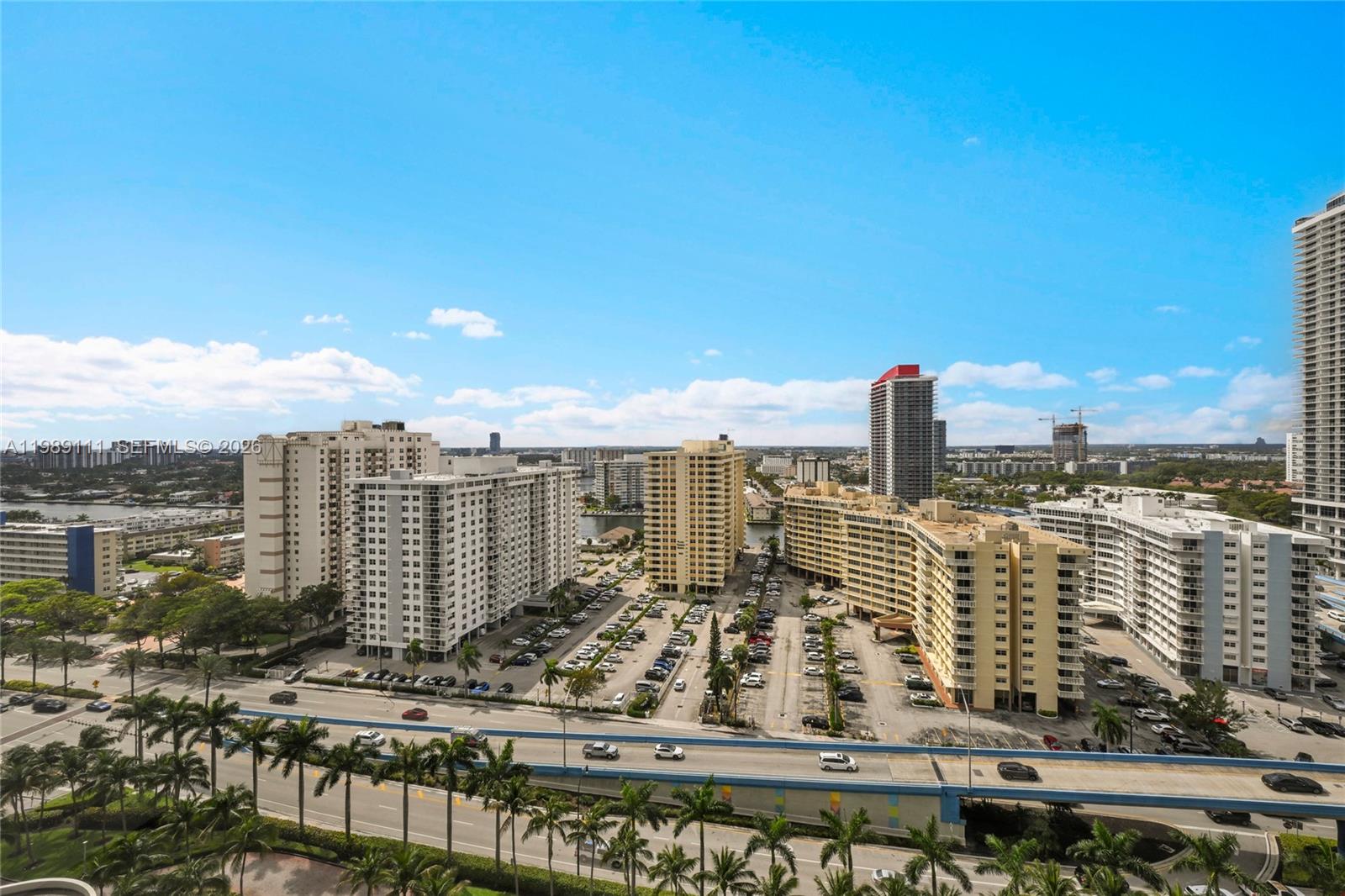 An elevated view of a city skyline featuring several high-rise buildings and a highway — 1830 S Ocean Dr # 1907, Hallandale Beach FL 33009, HALLANDALE BEACH, FL