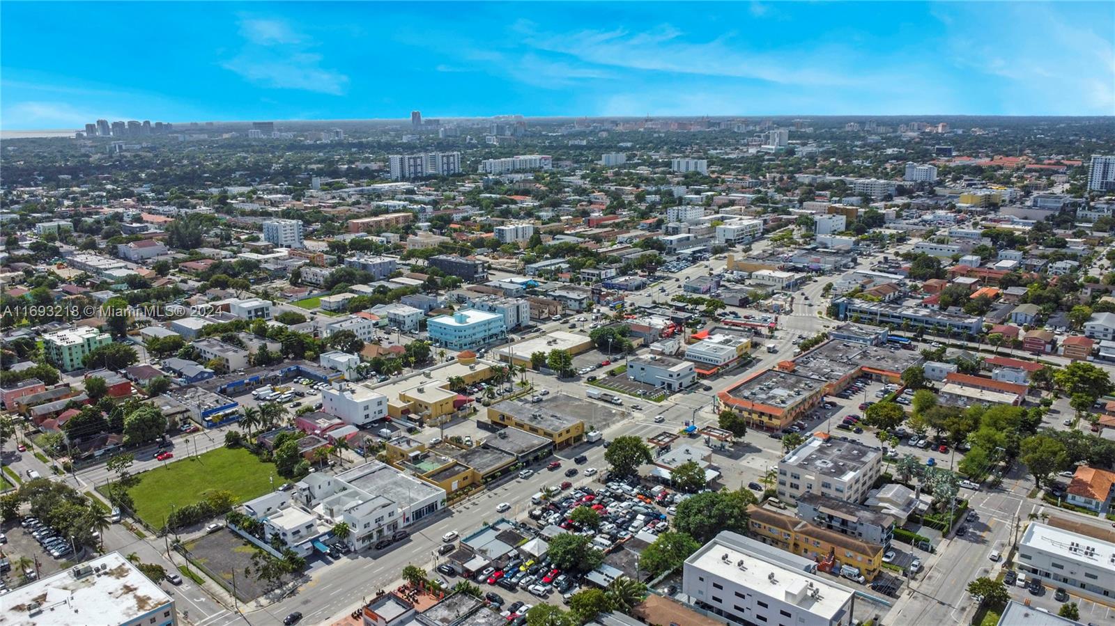 An aerial view shows a dense urban neighborhood with commercial buildings, parking lots, and residential areas — 1535 W Flagler St, Miami FL 33135, MIAMI, FL