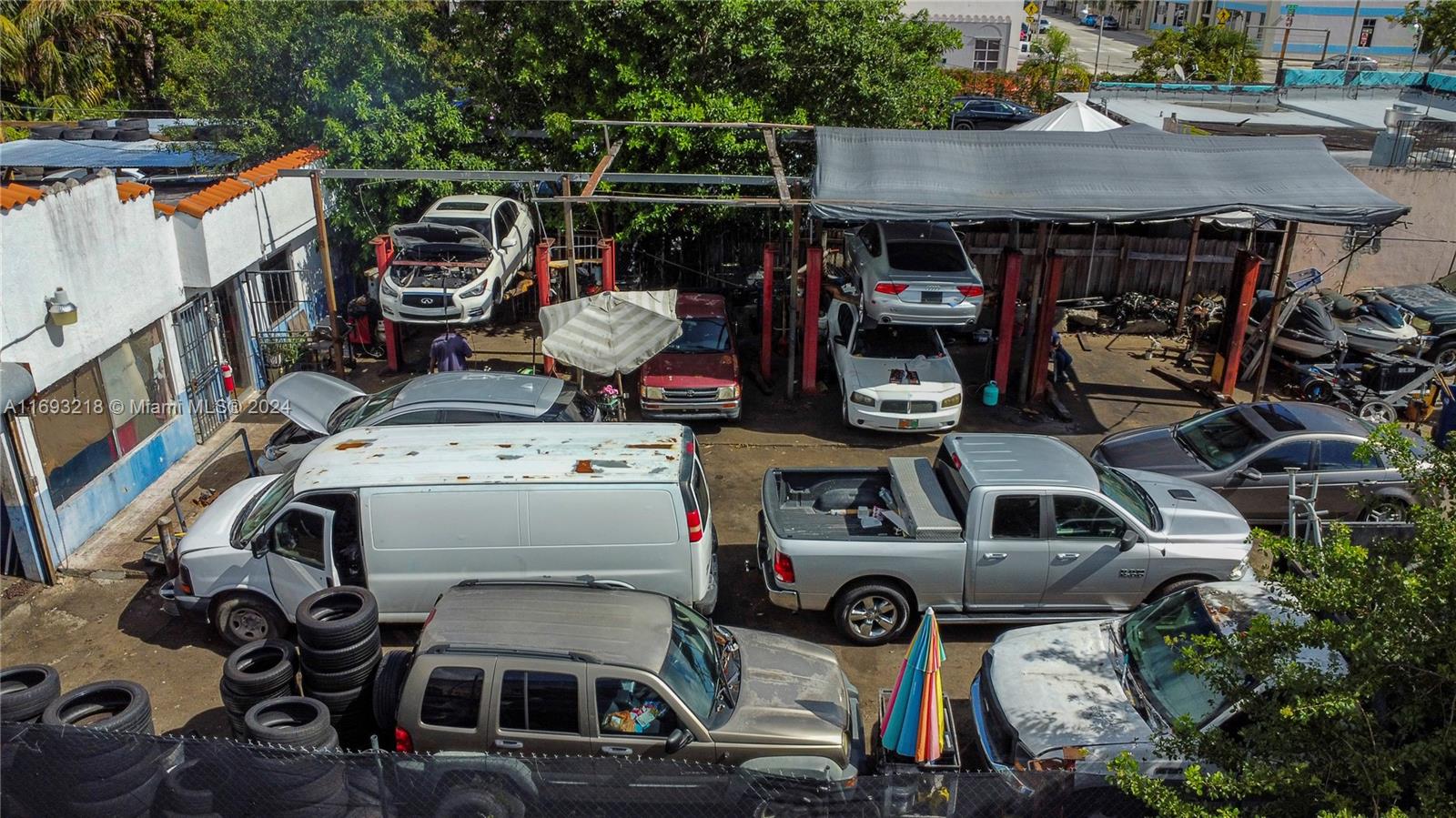 An aerial view shows an outdoor automotive repair shop with several vehicles being serviced — 1535 W Flagler St, Miami FL 33135, MIAMI, FL