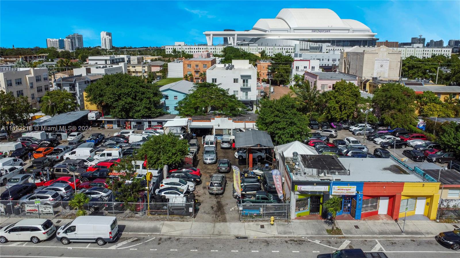 An aerial view shows a commercial property with a parking lot filled with many vehicles — 1535 W Flagler St, Miami FL 33135, MIAMI, FL