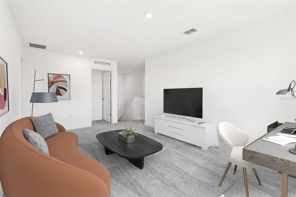 A modern living room features a curved orange sofa, a television, and a desk area — 926 CASTLEFORD AVENUE NE, PALM BAY, FL