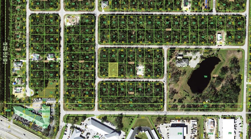 This is an aerial map showing residential lots, streets, and a pond — 18098 LUSCAR AVENUE, PORT CHARLOTTE, FL