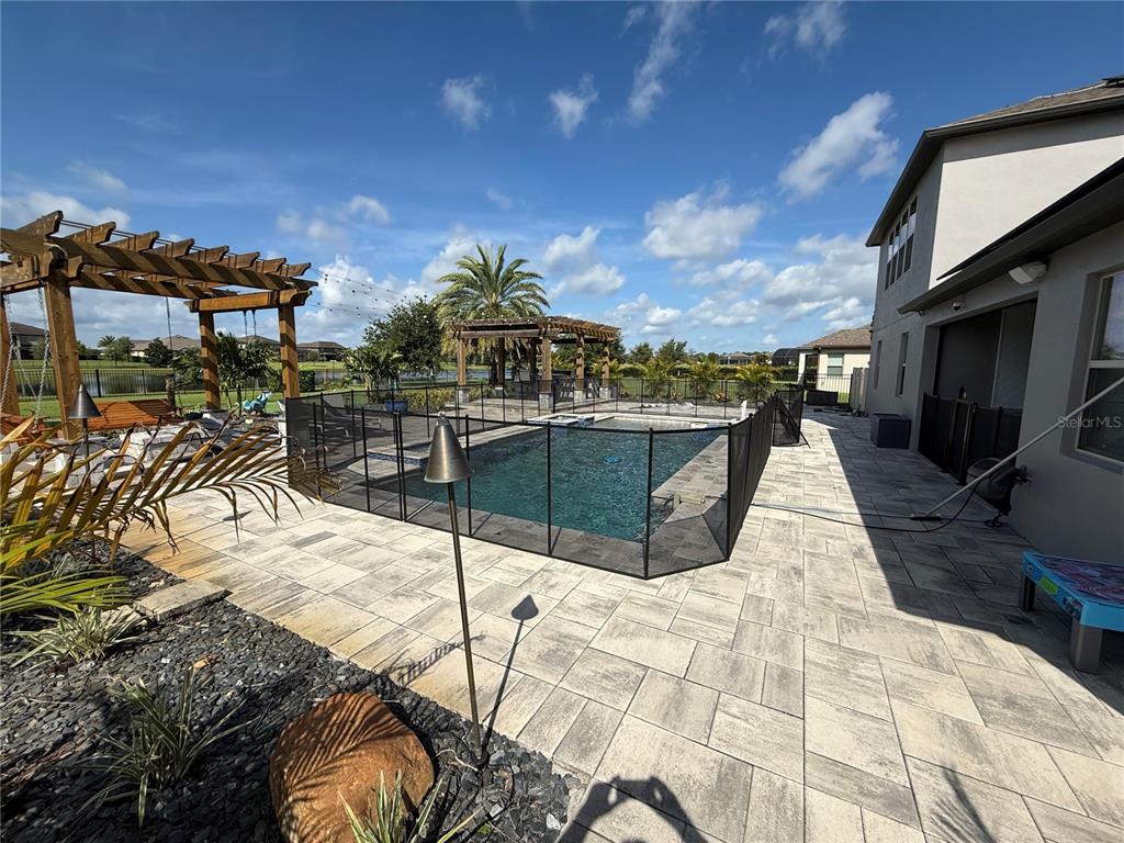 An aerial view shows a house with solar panels, a swimming pool, and a large yard — 17626 SAILFIN DRIVE, ORLANDO, FL