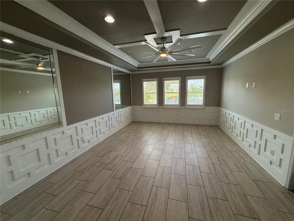 A bright living room features white sofas, a fireplace, and an adjacent dining area — 17626 SAILFIN DRIVE, ORLANDO, FL