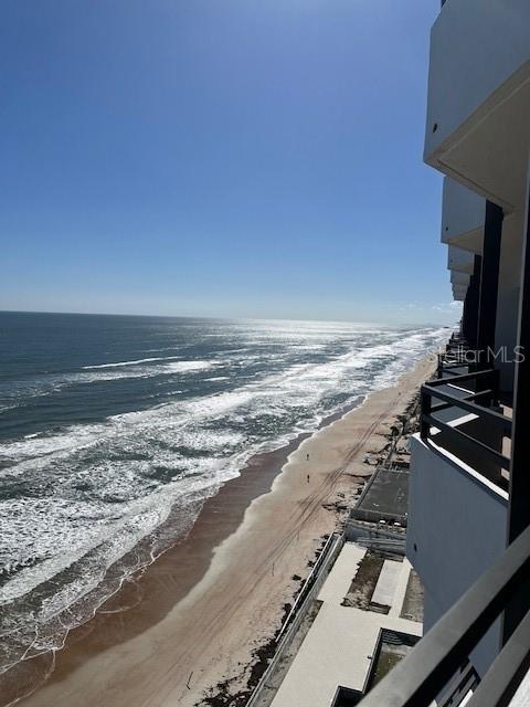 An elevated view of a sandy beach and ocean from a building balcony — 2828 N ATLANTIC AVENUE UNIT 1601, DAYTONA BEACH, FL