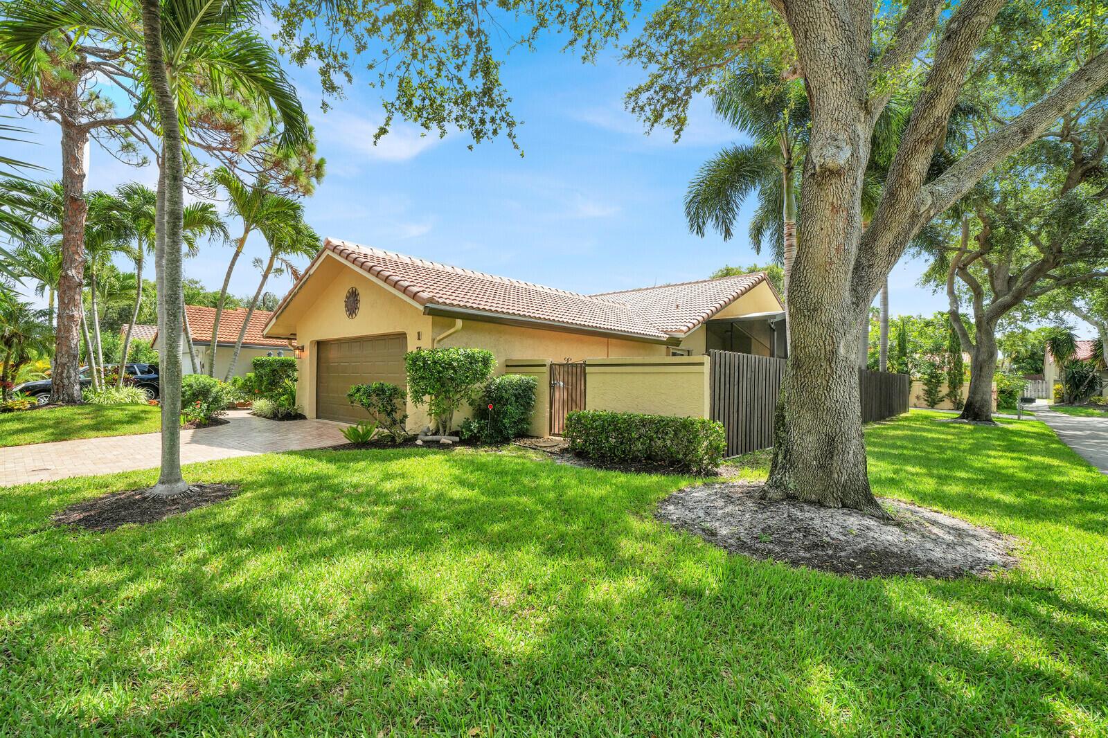 A single-story house with a tan stucco exterior, tile roof, and a two-car garage — 1735 NW 21st Court, Delray Beach FL 33445, DELRAY BEACH, FL
