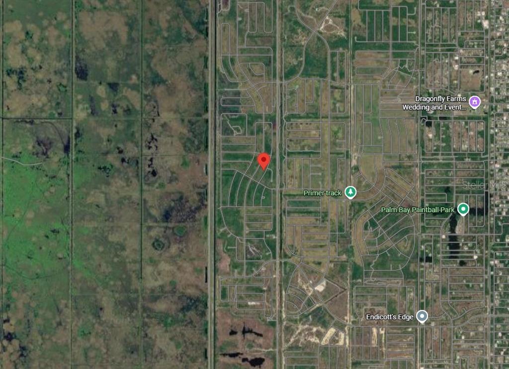 This is a satellite map view showing a red location pin in a residential area — 2466 LANDRUM AVENUE SW, PALM BAY, FL
