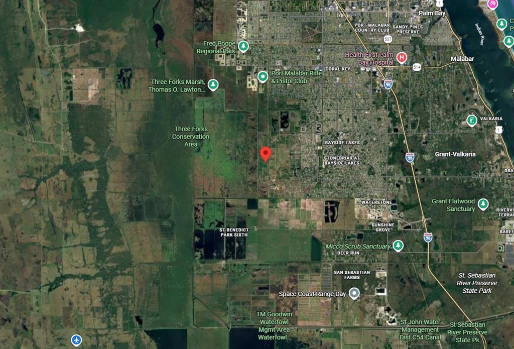 This is a satellite map showing the location of a property near conservation areas — 2466 LANDRUM AVENUE SW, PALM BAY, FL