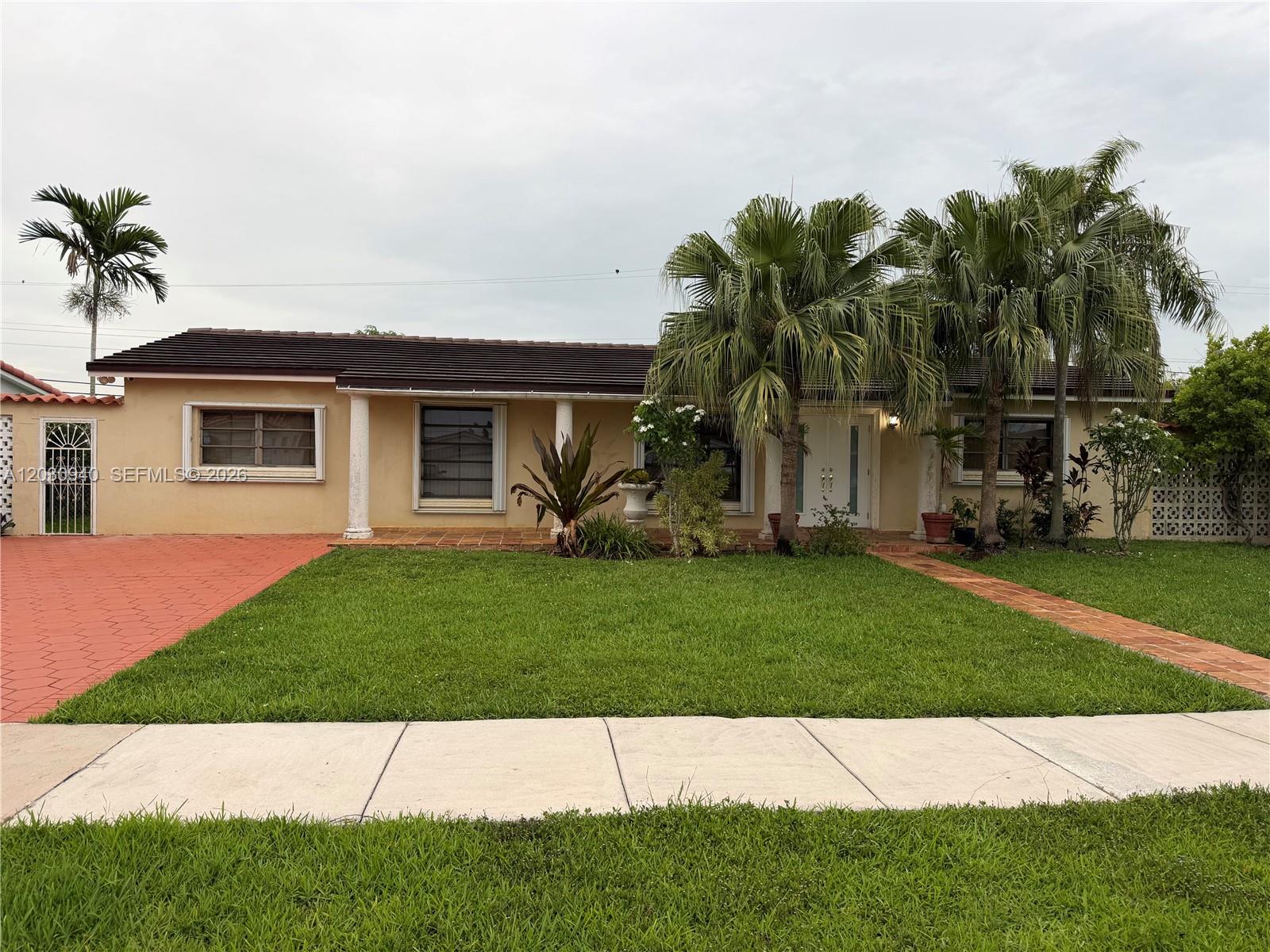 A single-story house with a tan exterior, a tiled roof, and palm trees in the yard — 3541 SW 125th Ct, Miami FL 33175, MIAMI, FL