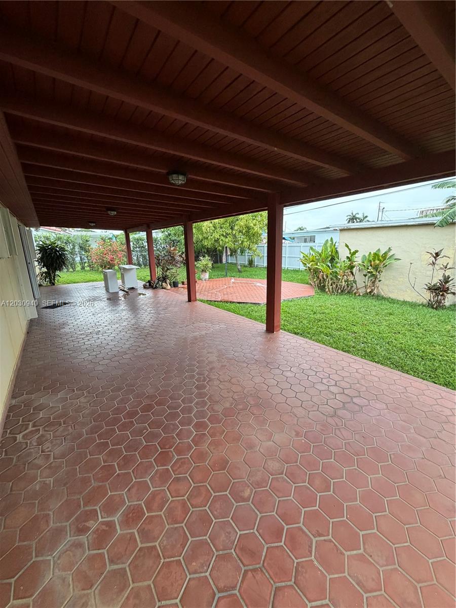 A covered patio features red hexagonal tile flooring and a wooden ceiling — 3541 SW 125th Ct, Miami FL 33175, MIAMI, FL