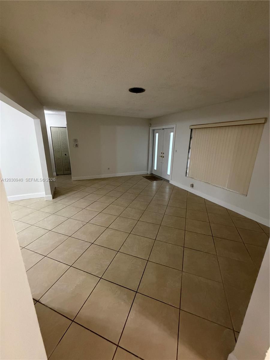 This room features light-colored walls, a tiled floor, and a double-door entryway — 3541 SW 125th Ct, Miami FL 33175, MIAMI, FL