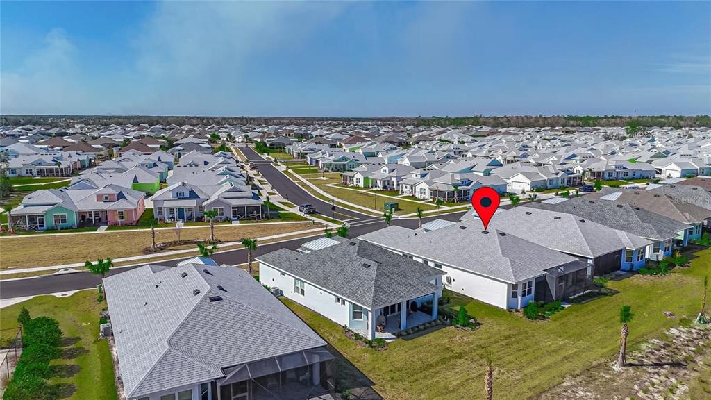 An aerial view shows a suburban neighborhood with single-family homes and a red location pin — 306 HANG LOOSE WAY, DAYTONA BEACH, FL