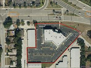 This aerial view shows a commercial property with a building and parking lot outlined in red — 3180 CURLEW ROAD UNIT 107, OLDSMAR, FL