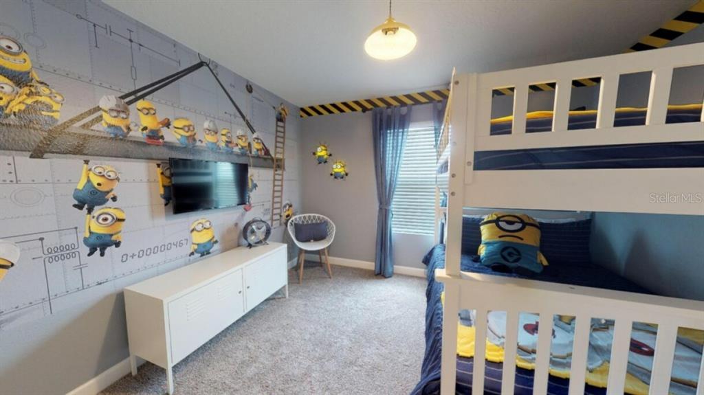 A bedroom features a white bunk bed, a Minion-themed mural, and a white media console — 4968 WINDERMERE AVENUE, KISSIMMEE, FL